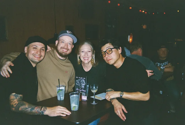 Four friends gathered around drinks at Easy Tiger.