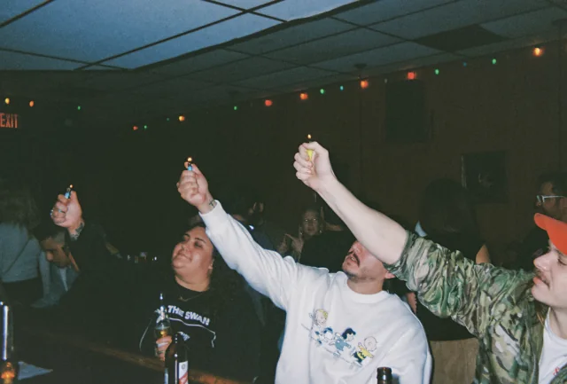 Guests raise lighters together at Easy Tiger.