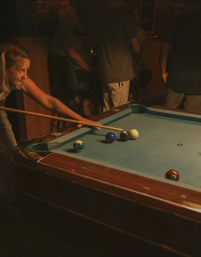 A guest shooting pool at Easy Tiger.